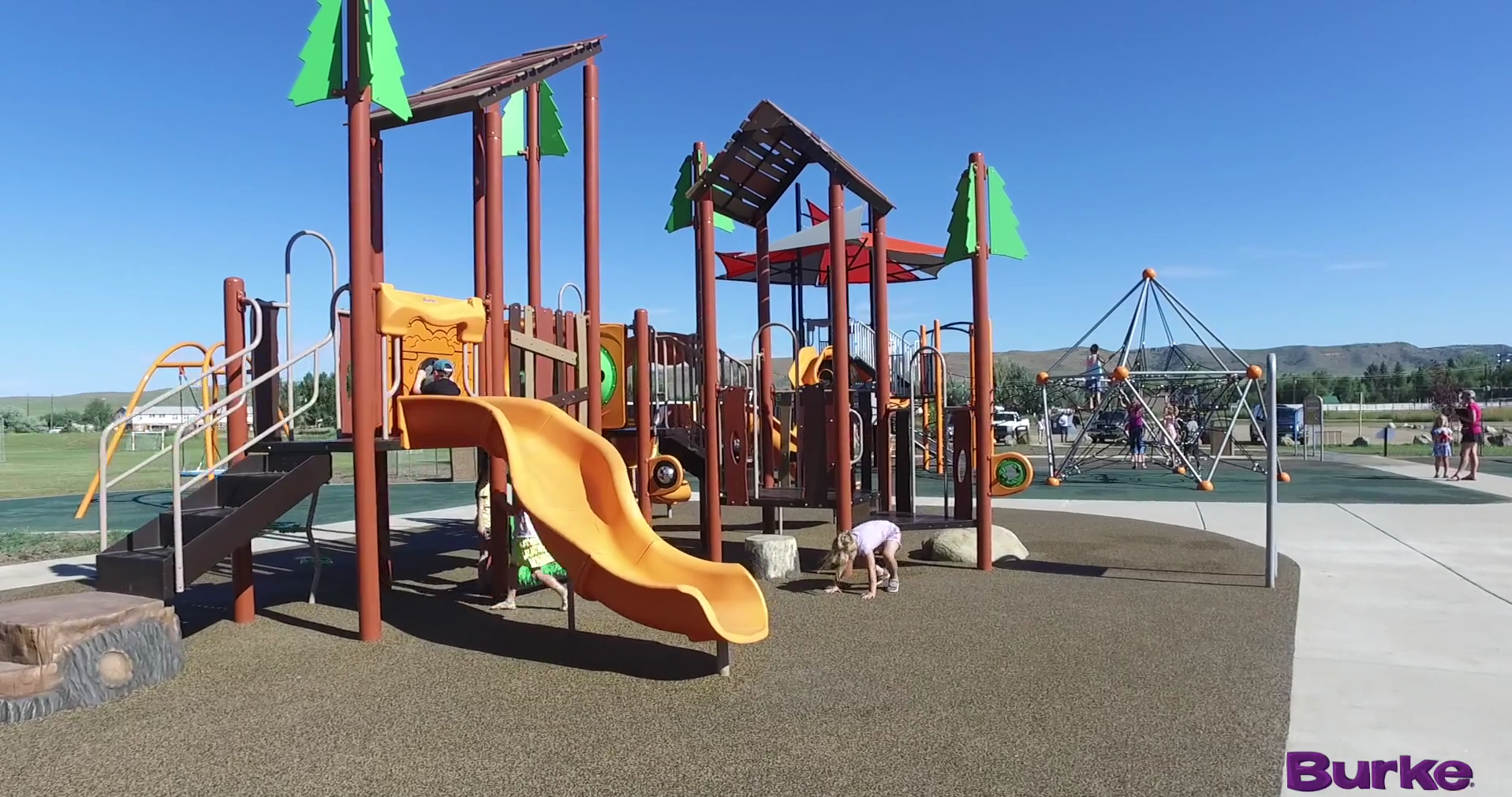 Children playing on the outdoor playground Dry Creek Park in Haydon Colorado created by AtoZ Recreation and BCI Burke.